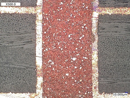 Osservazione di aree scolorite su una sezione trasversale di una PCB (500x)